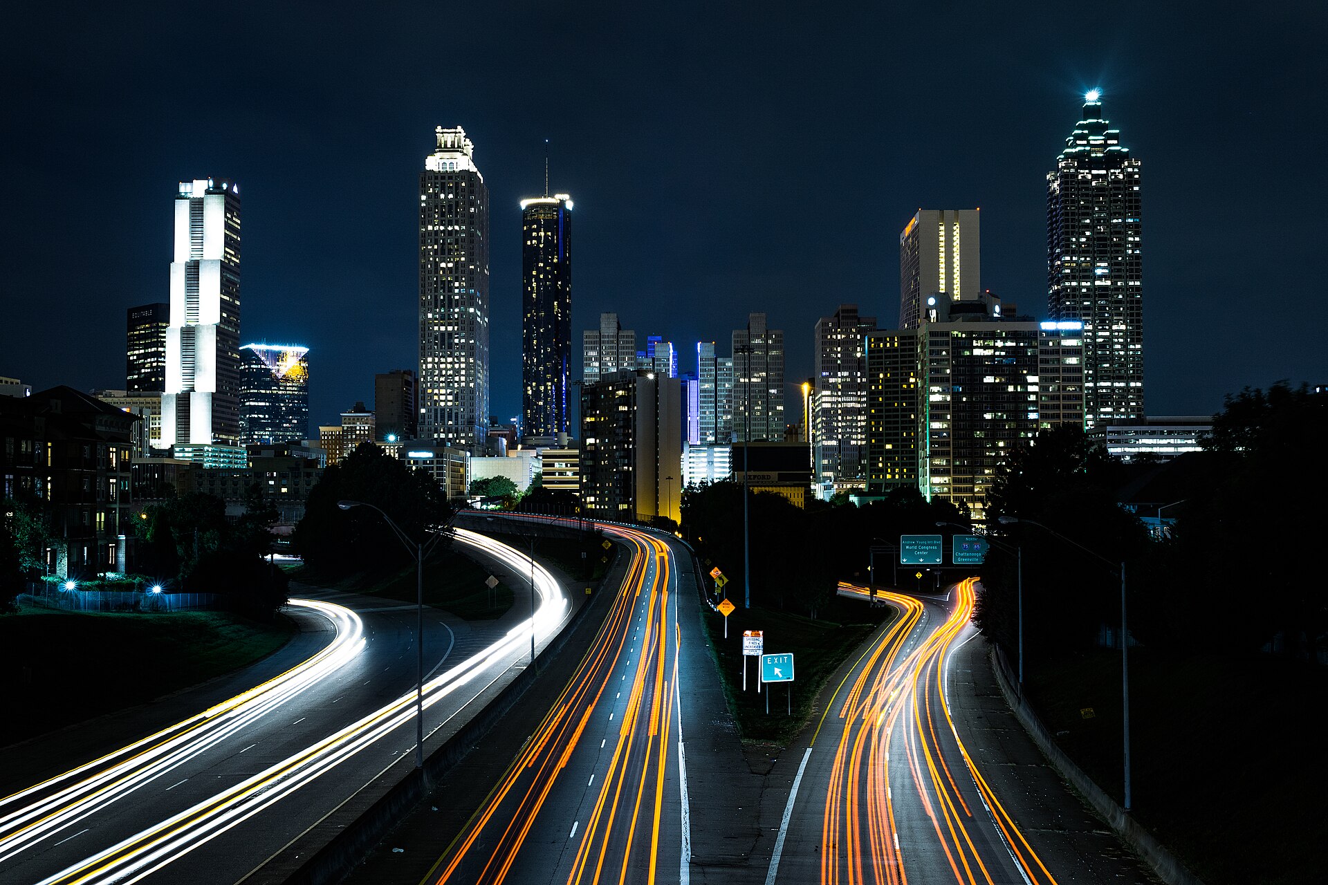 Downtown Atlanta at night, seen from the Jackson Street Bridge, with light trails on the highway